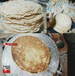 پخت هزار قرص نان محلی برای زائران تشییع رهبر شهید در روستای تنگ خشک باغملک
